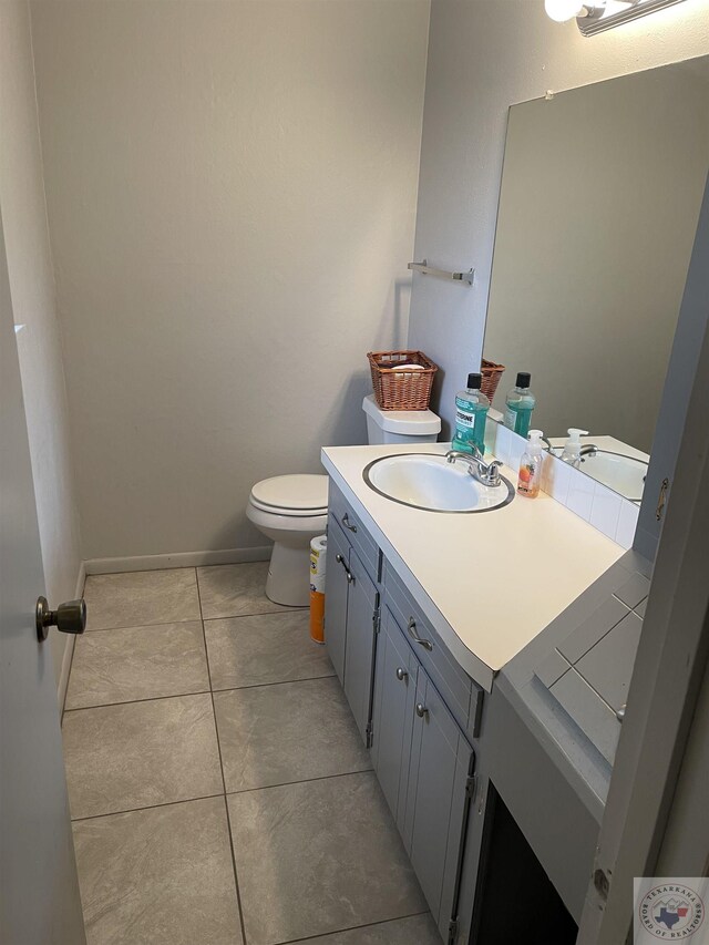 bathroom with tile patterned floors, vanity, and toilet