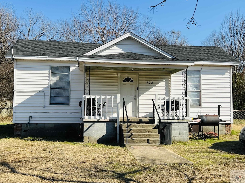 view of front of home with a front yard and a porch