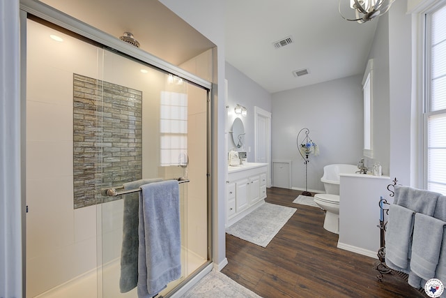 501 Main St, Texarkana, TX 75501 - bathroom with wood finished floors, visible vents, vanity, and a stall shower