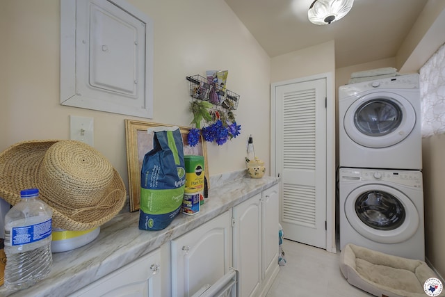 501 Main St, Texarkana, TX 75501 - washroom with electric panel, stacked washing maching and dryer, and cabinet space
