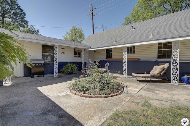 501 Main St, Texarkana, TX 75501 - back of property with roof with shingles and a patio