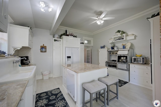 501 Main St, Texarkana, TX 75501 - kitchen featuring a ceiling fan, tasteful backsplash, light wood-style floors, white appliances, and white cabinetry