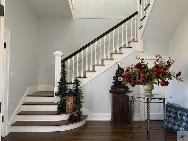 stairs featuring wood finished floors