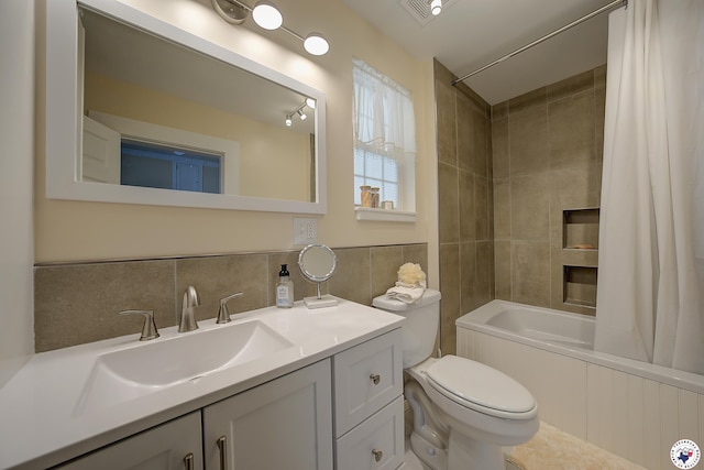 501 Main St, Texarkana, TX 75501 - full bathroom featuring toilet, tile walls, visible vents, shower / bath combo with shower curtain, and vanity