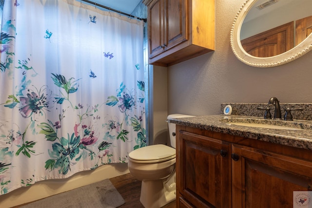 bathroom with vanity, toilet, curtained shower, and wood-type flooring