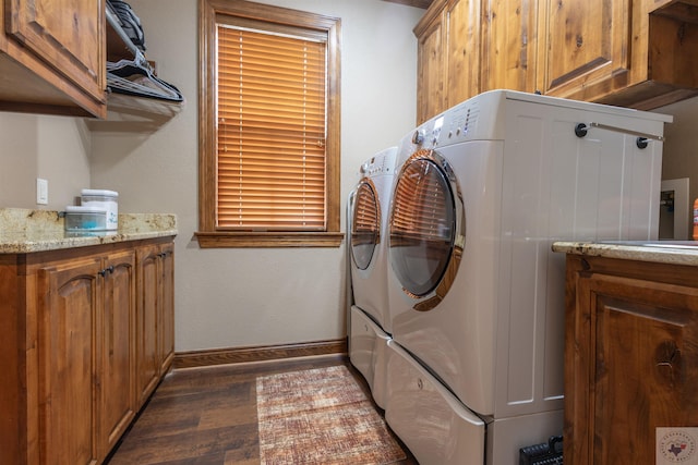 washroom with cabinets, dark hardwood / wood-style flooring, and washing machine and dryer