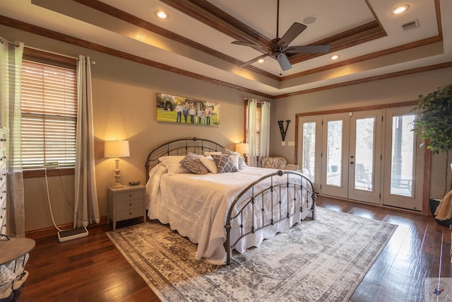 bedroom featuring dark hardwood / wood-style flooring, access to exterior, ornamental molding, ceiling fan, and a tray ceiling