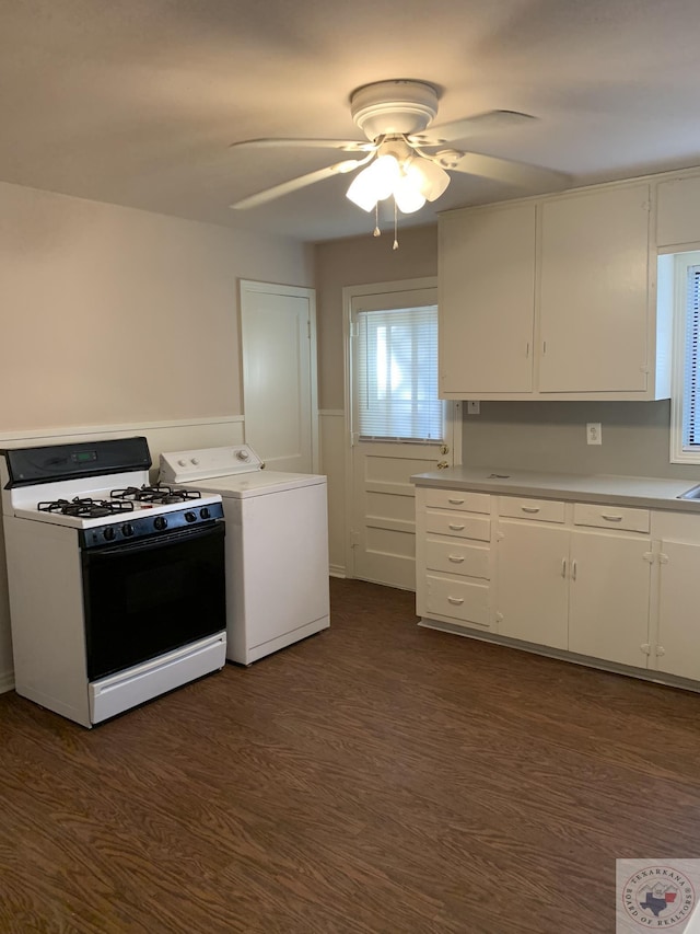 kitchen with washer / dryer, range with gas stovetop, white cabinets, dark wood-type flooring, and ceiling fan