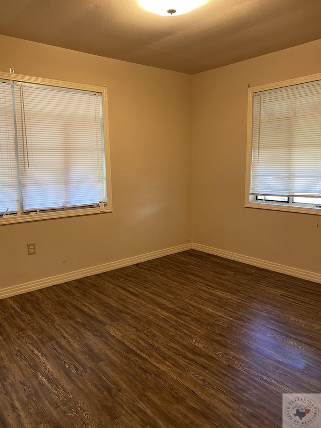 spare room featuring dark wood-type flooring