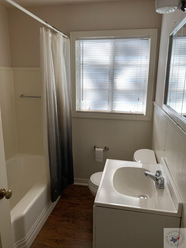 full bathroom featuring plenty of natural light, hardwood / wood-style floors, toilet, and sink