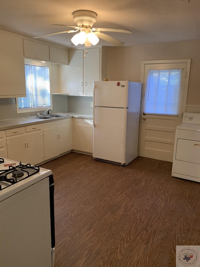 kitchen featuring sink, white appliances, white cabinets, and washer / dryer