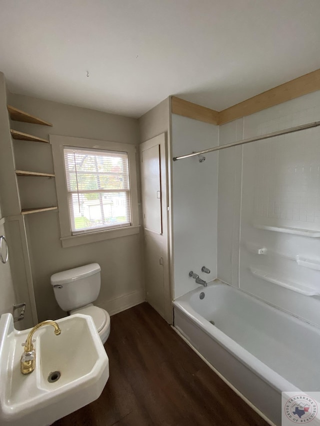 full bathroom with sink, toilet, hardwood / wood-style floors, and shower / washtub combination