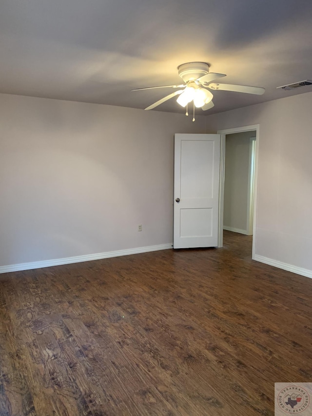 empty room featuring ceiling fan and dark hardwood / wood-style flooring