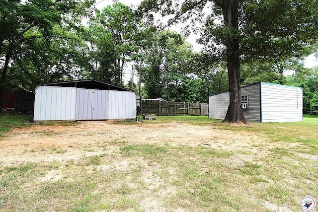 632 White Oak Rd, Maud, TX 75567 - view of yard featuring a carport, view of wooded area, and a storage shed