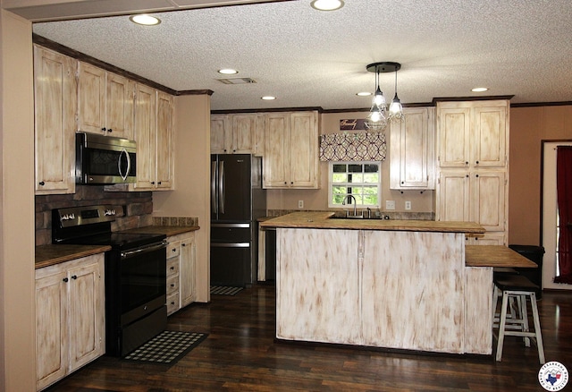 632 White Oak Rd, Maud, TX 75567 - kitchen with stainless steel microwave, electric stove, freestanding refrigerator, a center island, and light brown cabinets