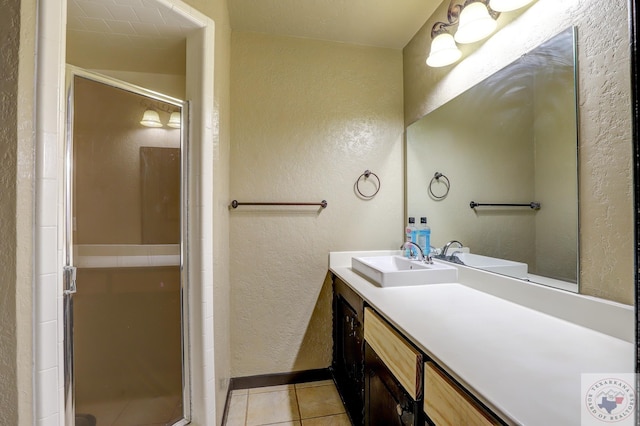 bathroom with vanity, a shower with shower door, and tile patterned flooring