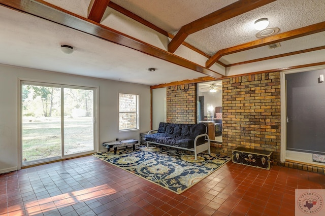 tiled living room featuring brick wall and a textured ceiling