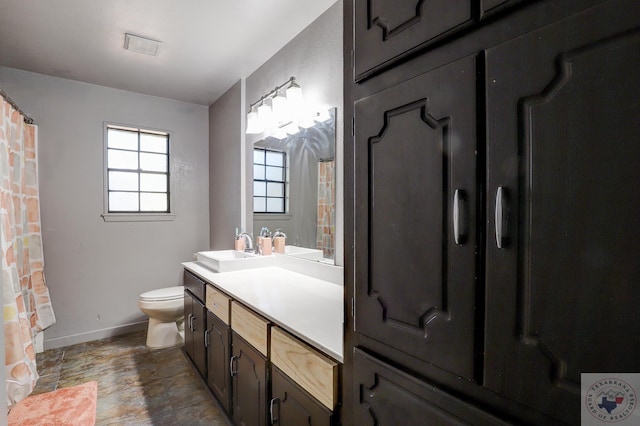 bathroom featuring toilet and vanity