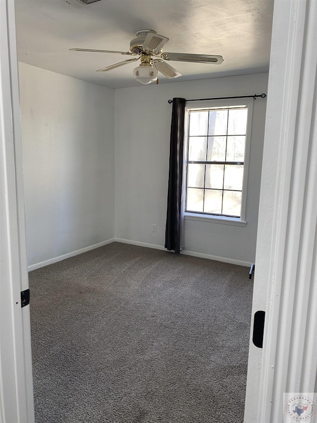 empty room with baseboards, a ceiling fan, and carpet flooring