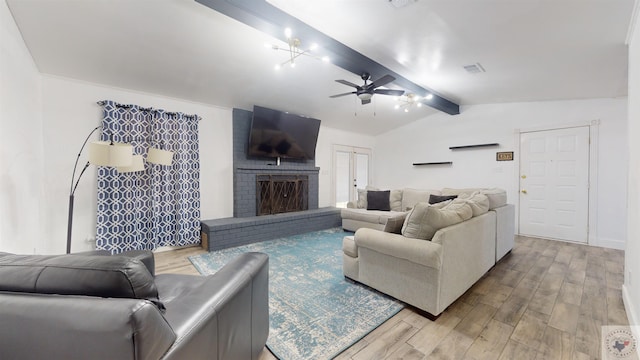 living room with visible vents, vaulted ceiling with beams, a ceiling fan, and wood finished floors