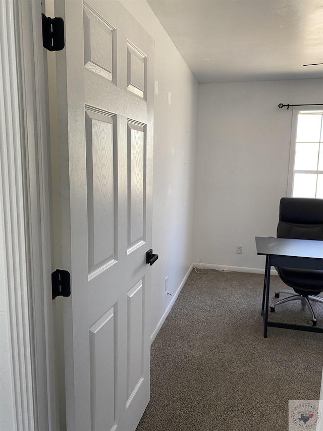 carpeted home office with baseboards