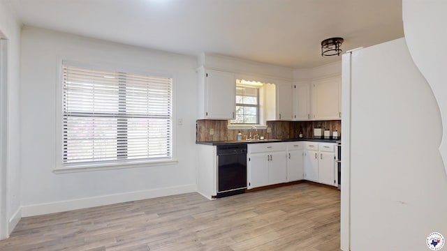 kitchen featuring white cabinets, dishwasher, light wood finished floors, dark countertops, and freestanding refrigerator