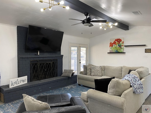 living room with a ceiling fan, vaulted ceiling with beams, a fireplace, and visible vents