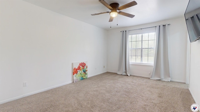 empty room with a ceiling fan, carpet, and baseboards