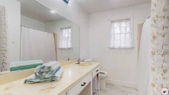 bathroom featuring marble finish floor, baseboards, toilet, and vanity