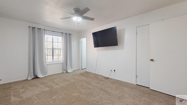 spare room featuring ceiling fan and light carpet