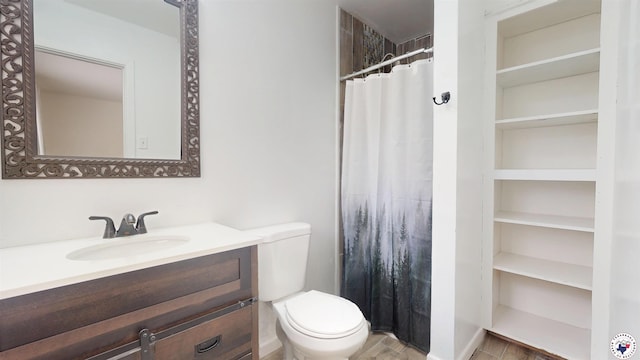 bathroom with toilet, vanity, and curtained shower