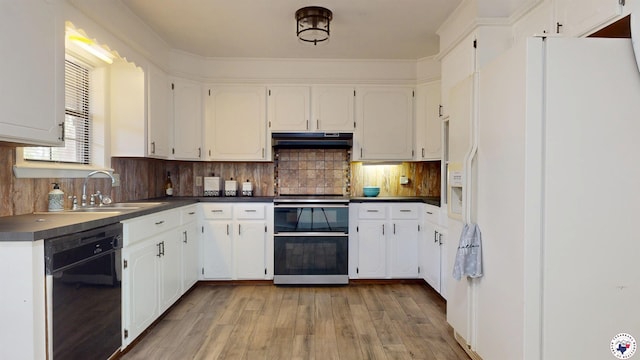 kitchen with double oven range, white fridge with ice dispenser, dishwasher, under cabinet range hood, and dark countertops