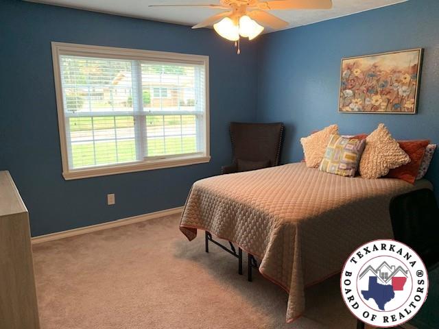 bedroom featuring baseboards, carpet flooring, and ceiling fan