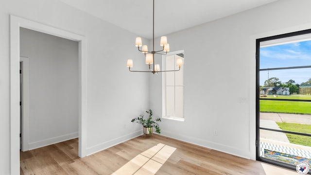 7312 Shadow Brooke, Texarkana, TX 75503 - unfurnished dining area with light wood-style floors, a chandelier, and baseboards