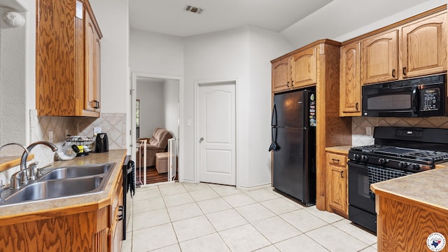 6 Meredith Way, Texarkana, TX 75501 - kitchen with visible vents, light tile patterned flooring, tasteful backsplash, a sink, and black appliances