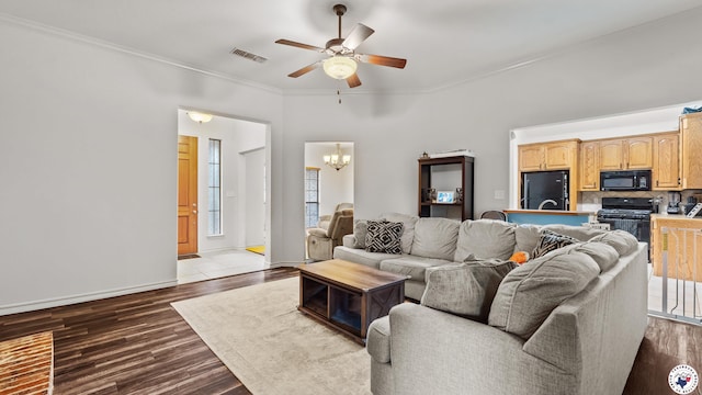6 Meredith Way, Texarkana, TX 75501 - living area with visible vents, dark wood-style flooring, crown molding, and ceiling fan with notable chandelier