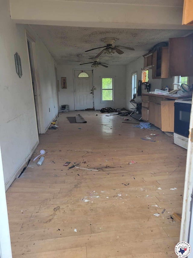 3325 Findley St, Texarkana, TX 75501 - kitchen featuring wood-type flooring, black electric range, ceiling fan, and open floor plan