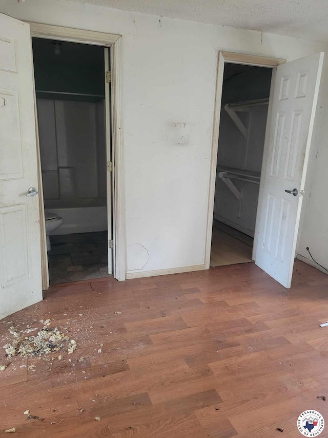 3325 Findley St, Texarkana, TX 75501 - unfurnished bedroom featuring wood finished floors and connected bathroom