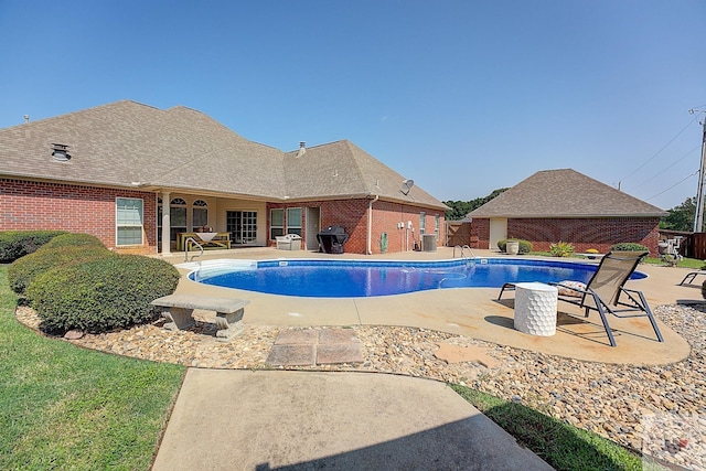 view of swimming pool with a patio