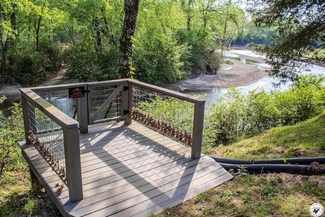 wooden deck featuring a view of trees