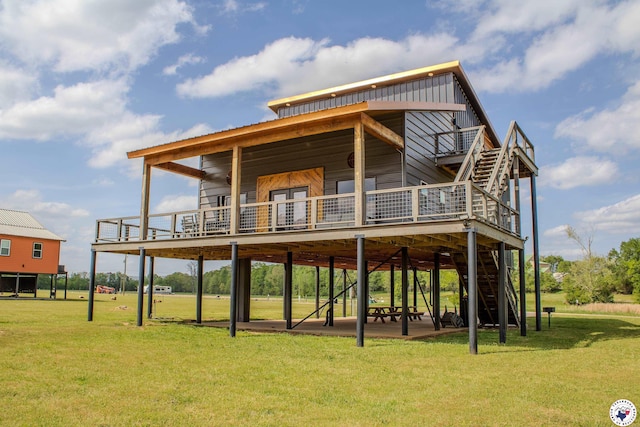 back of house featuring a wooden deck, a lawn, and stairway