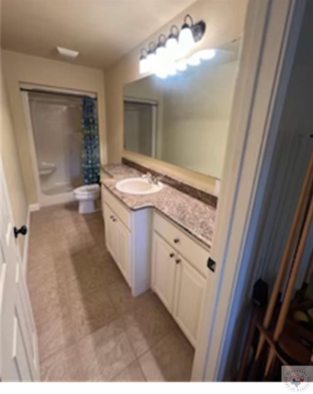 bathroom featuring walk in shower and vanity