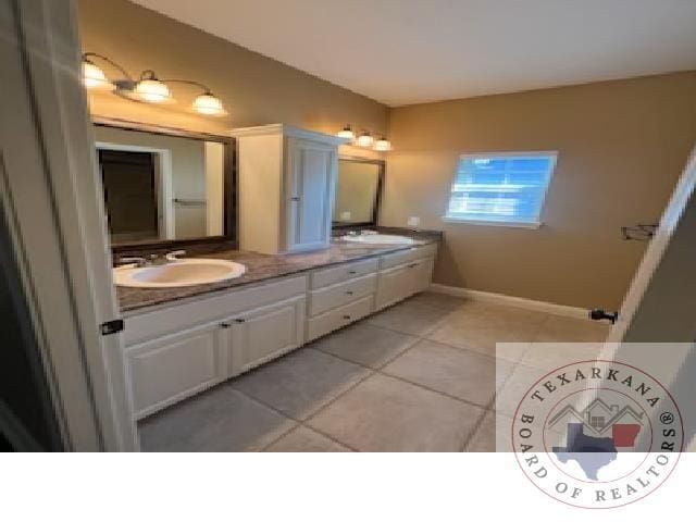 bathroom featuring tile patterned floors and vanity