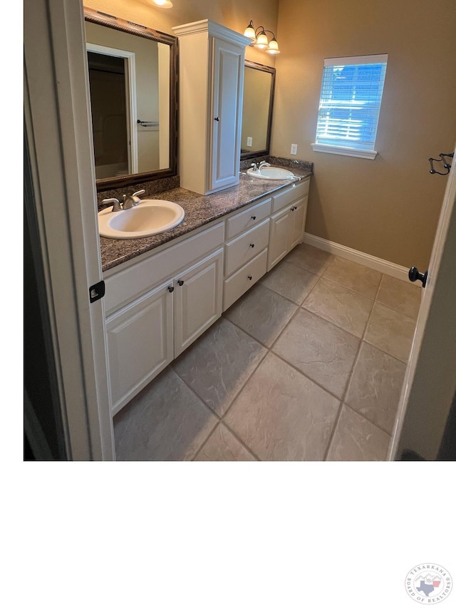 bathroom with vanity and tile patterned flooring