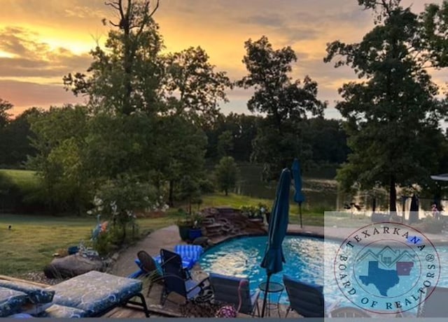 view of pool at dusk