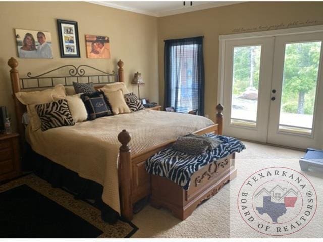 bedroom with light colored carpet, access to outside, and french doors