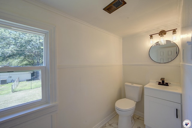 4201 Pine St, Texarkana, TX 75501 - half bathroom featuring vanity, toilet, ornamental molding, and marble look tile flooring