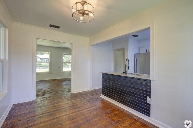 4201 Pine St, Texarkana, TX 75501 - hall featuring dark wood finished floors, a sink, ornamental molding, baseboards, and a chandelier