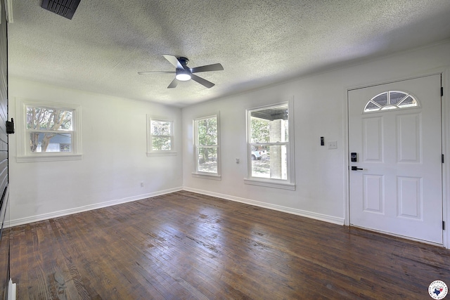 4201 Pine St, Texarkana, TX 75501 - foyer entrance with a textured ceiling, dark wood-style flooring, ceiling fan, plenty of natural light, and baseboards