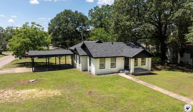 4201 Pine St, Texarkana, TX 75501 - view of front of property with a shingled roof, a front yard, stucco siding, and a detached carport